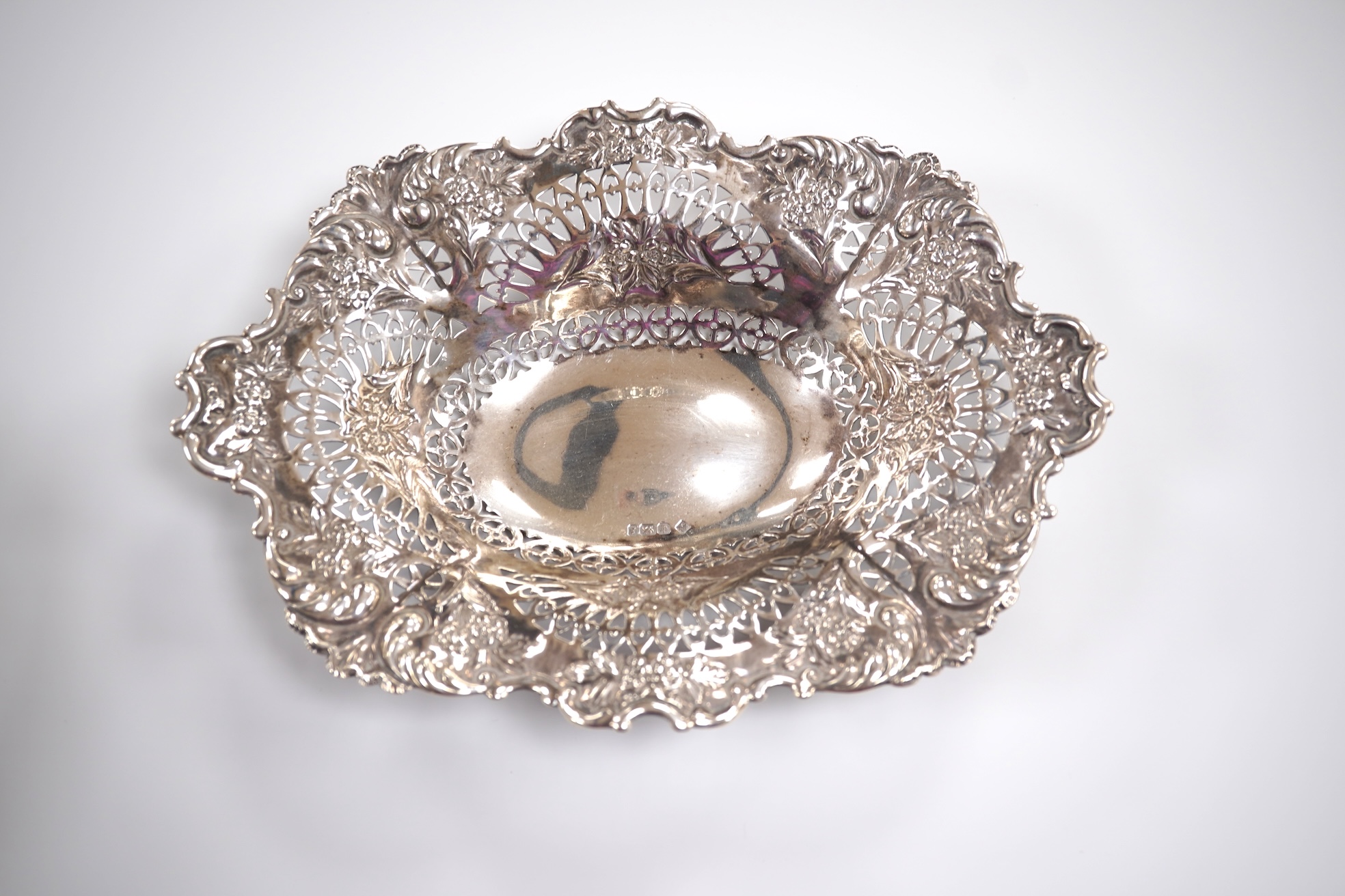 A late Victorian repousse silver oval bonbon dish, Martin, Hall & Co, Sheffield, 1895, length 20.8cm, together with an Elizabeth II pieced silver pedestal bonbon dish by Asprey & Co Ltd, London, 1965, 10.8oz.
